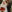 Billy Ray Cyrus and Firerose on their wedding day in October 2023. She is holding a red and orange bouquet and wearing a white dress. Cyris is wearing a black tux.